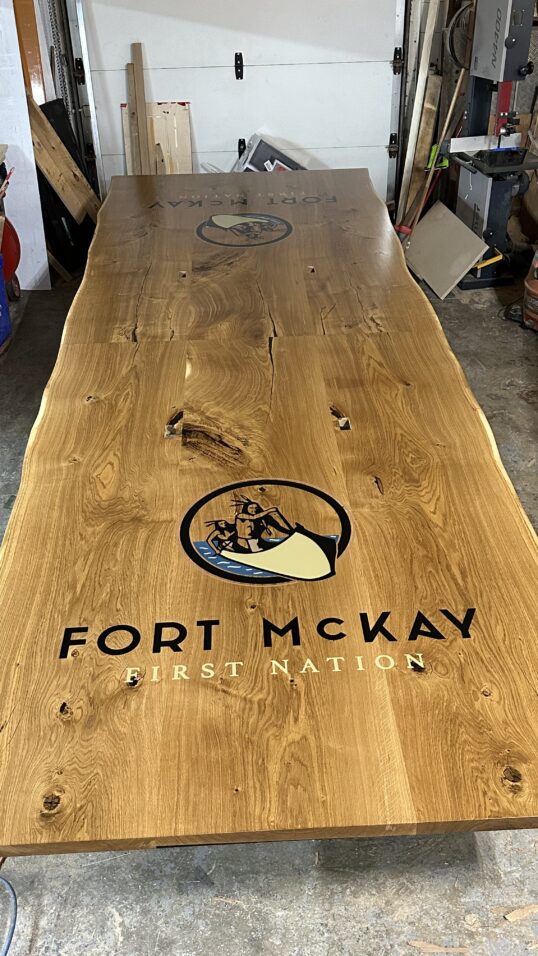 Massive white oak conference table featuring two 4x4 epoxy logos White Oak conference table