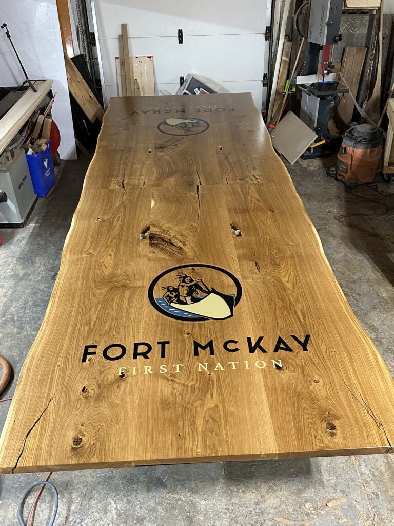 Massive white oak conference table featuring two 4x4 epoxy logos White Oak conference table