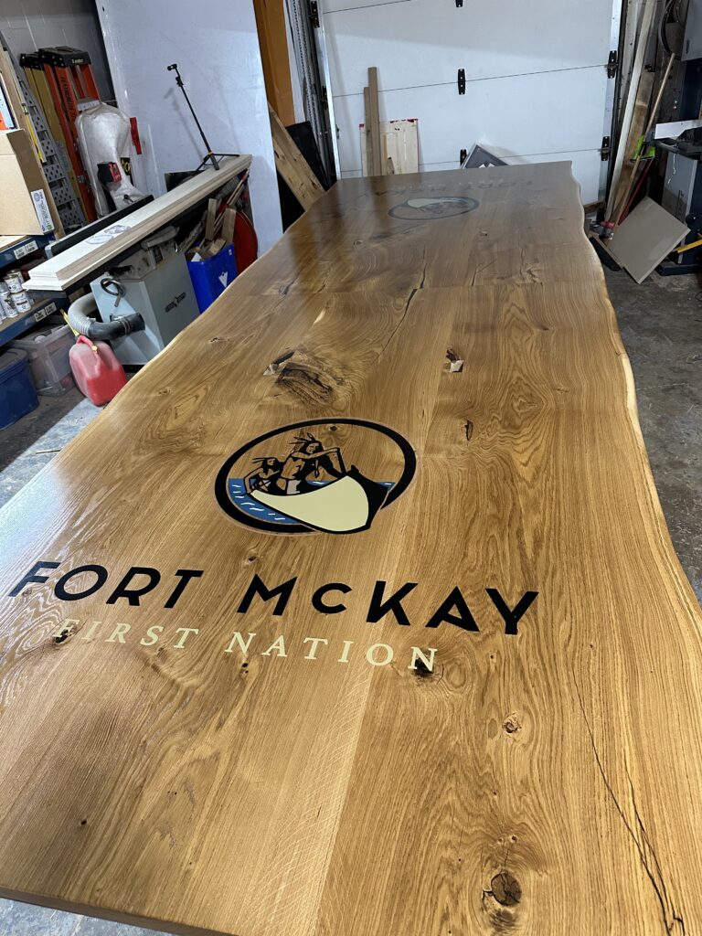 Massive white oak conference table featuring two 4x4 epoxy logos White Oak conference table