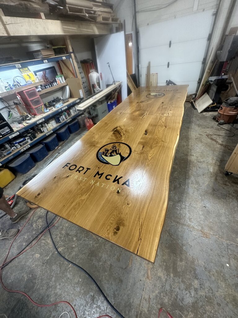 Massive white oak conference table featuring two 4x4 epoxy logos White Oak conference table